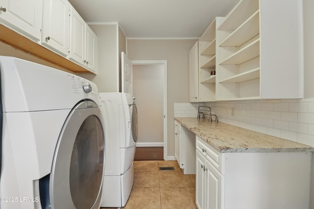 41 Able St, Bluffton, SC 29910 - clothes washing area with washer and clothes dryer, light tile patterned floors, cabinet space, crown molding, and baseboards