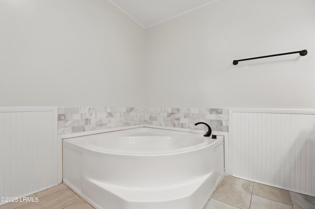 41 Able St, Bluffton, SC 29910 - bathroom with wainscoting, a garden tub, and crown molding