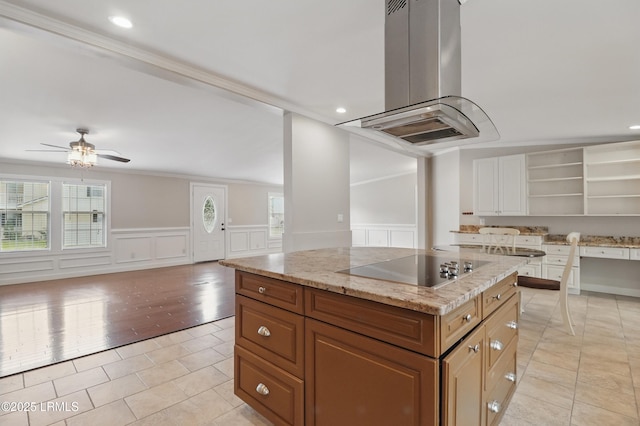 41 Able St, Bluffton, SC 29910 - kitchen featuring island range hood, light tile patterned flooring, open shelves, black electric stovetop, and healthy amount of natural light