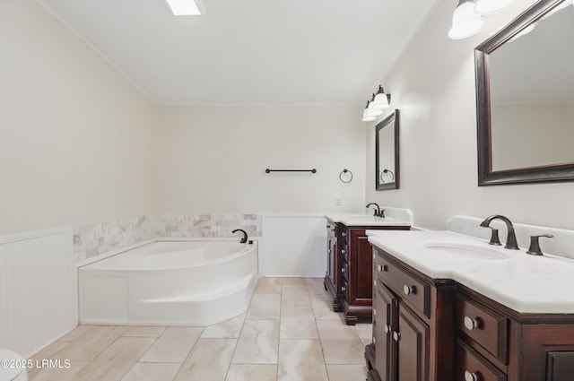 41 Able St, Bluffton, SC 29910 - bathroom featuring a wainscoted wall, a bath, and two vanities