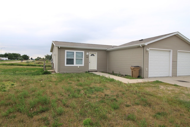 ranch-style home featuring a front yard and a garage