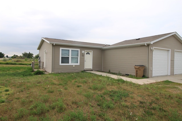 ranch-style house with a front lawn and a garage