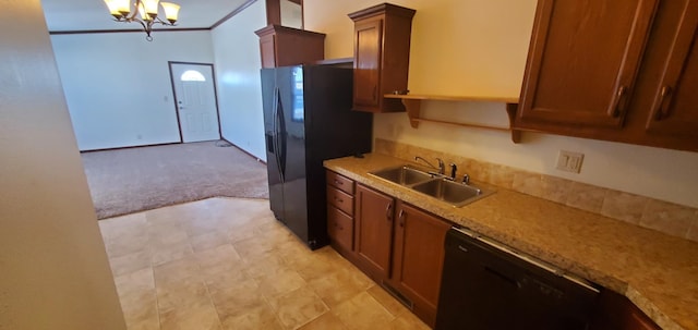 kitchen featuring an inviting chandelier, light stone counters, light carpet, black appliances, and sink