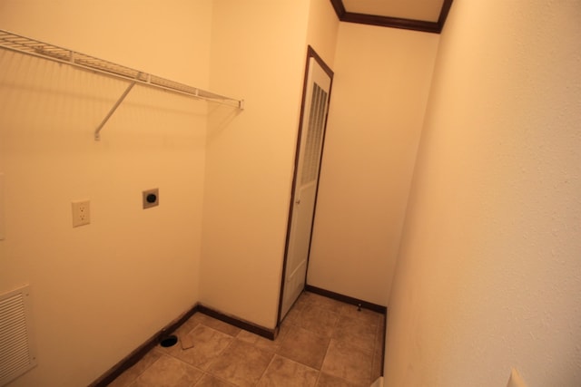 laundry room featuring electric dryer hookup and light tile floors