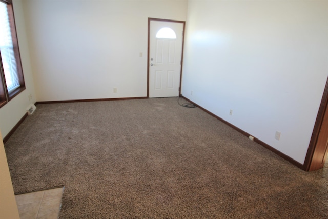 spare room featuring light carpet