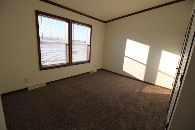 unfurnished room with dark carpet and ornamental molding