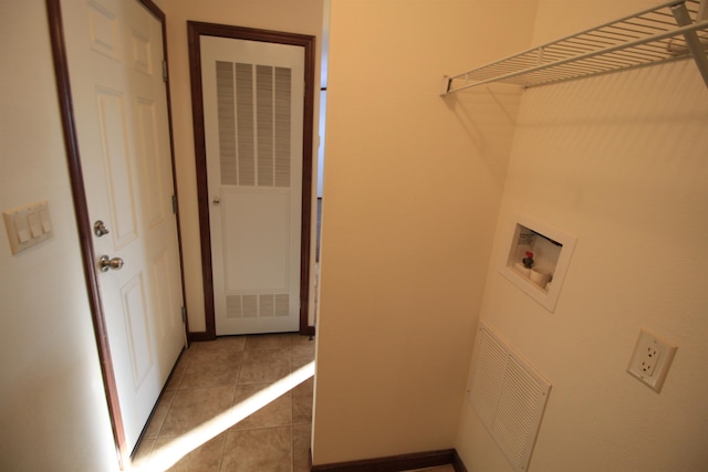 washroom featuring washer hookup and light tile floors