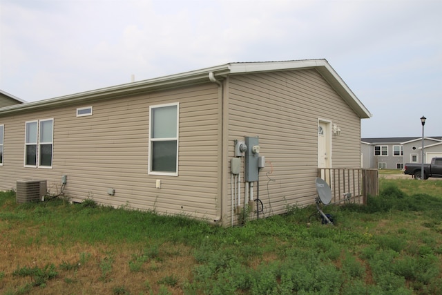 view of side of property featuring central air condition unit