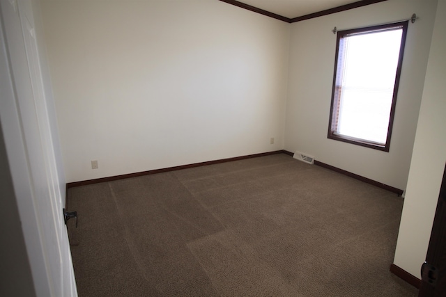 carpeted spare room featuring crown molding