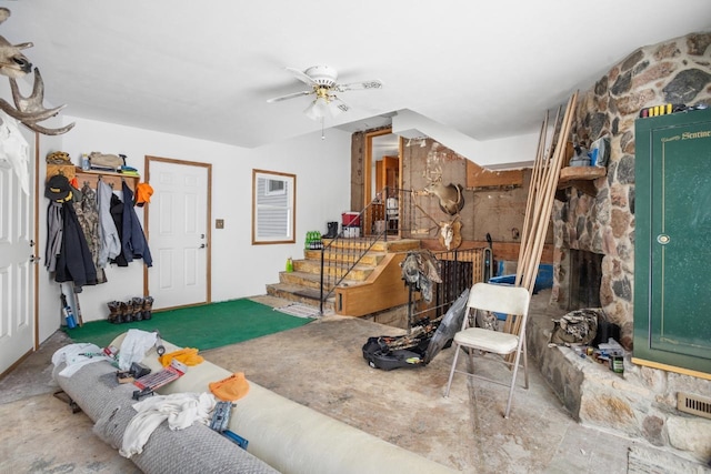 interior space with ceiling fan and a fireplace