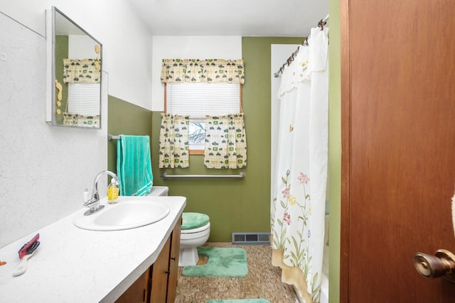 bathroom featuring tile flooring, toilet, and oversized vanity