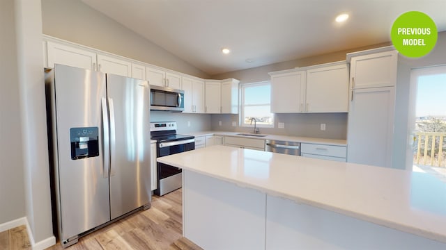 kitchen featuring white cabinets, light wood-type flooring, sink, and stainless steel appliances