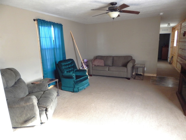 carpeted living room featuring a ceiling fan and visible vents