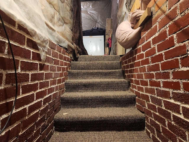 staircase with brick wall