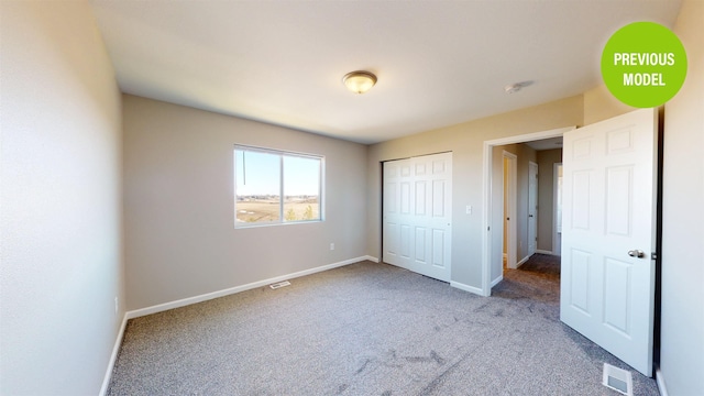 unfurnished bedroom featuring a closet and light carpet