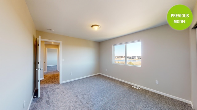 unfurnished bedroom with dark carpet