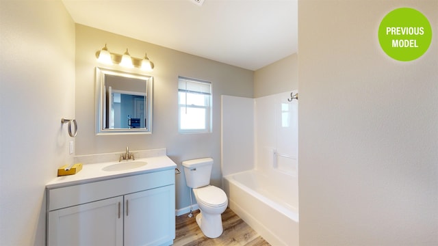 full bathroom featuring shower / bathing tub combination, toilet, large vanity, and hardwood / wood-style flooring