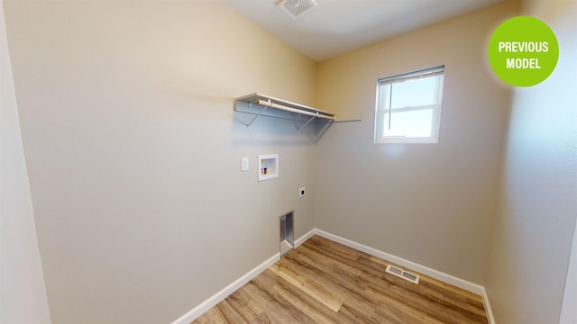 washroom with washer hookup, electric dryer hookup, and light wood-type flooring