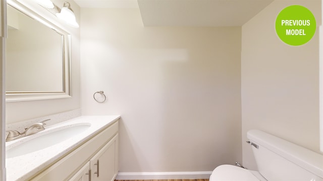 bathroom with large vanity and toilet