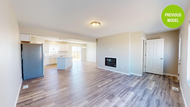 unfurnished living room featuring light hardwood / wood-style floors