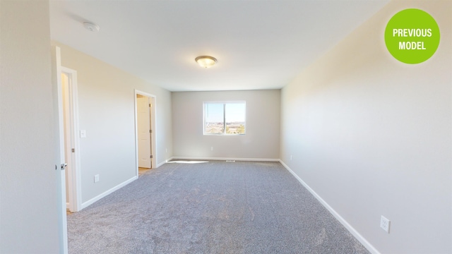 spare room featuring light carpet