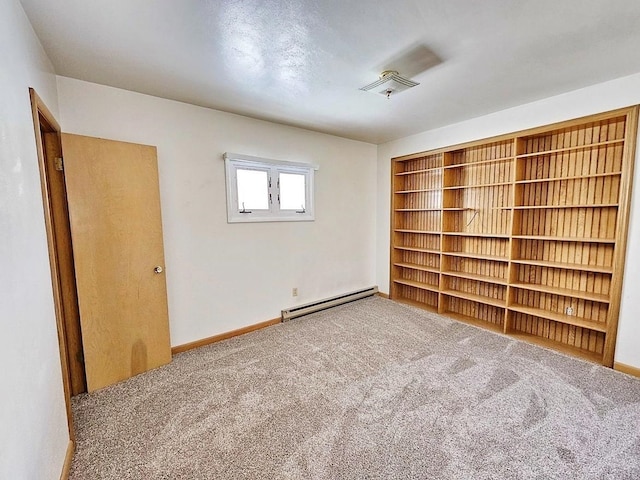 810 2nd Ave, Kenmare, ND 58746 - spare room with light carpet and a baseboard heating unit
