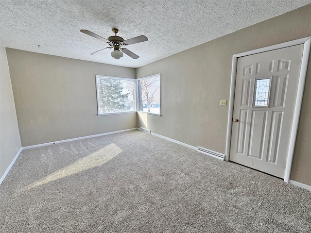810 2nd Ave, Kenmare, ND 58746 - spare room with light carpet, ceiling fan, a textured ceiling, and a baseboard heating unit