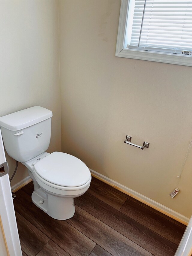 bathroom featuring wood-type flooring and toilet