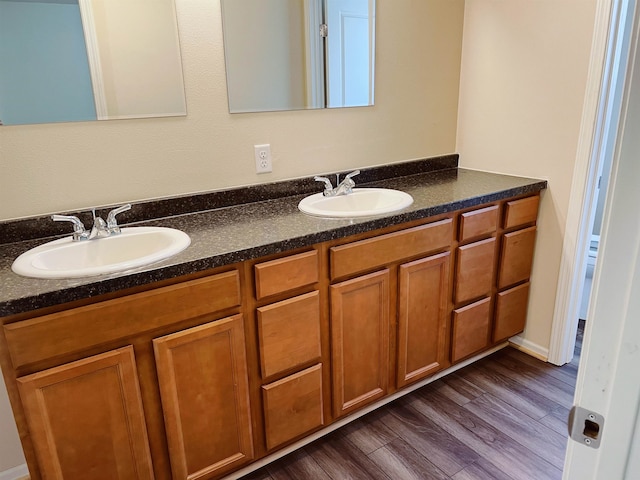 bathroom featuring dual vanity and hardwood / wood-style floors