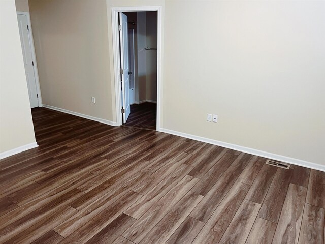 unfurnished room featuring dark hardwood / wood-style floors