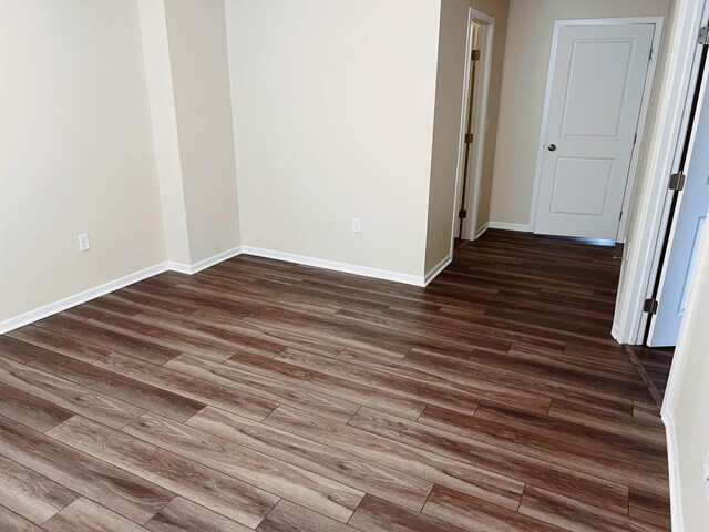 empty room with dark hardwood / wood-style floors