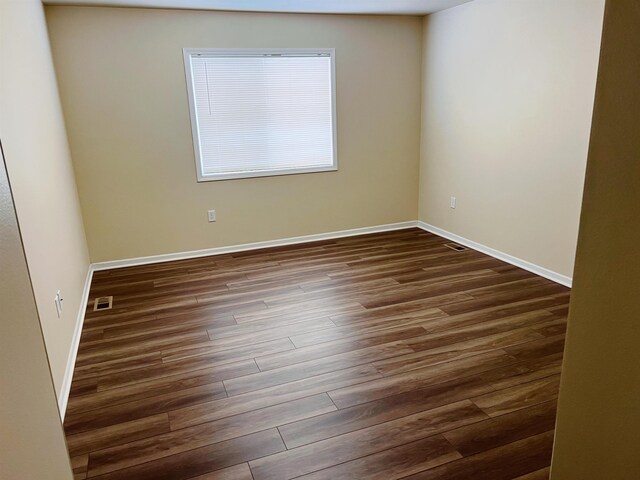 empty room featuring dark hardwood / wood-style flooring