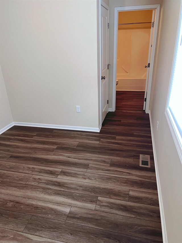 hall with dark hardwood / wood-style flooring