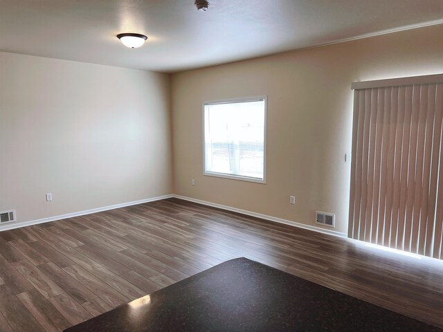 unfurnished room featuring dark wood-type flooring