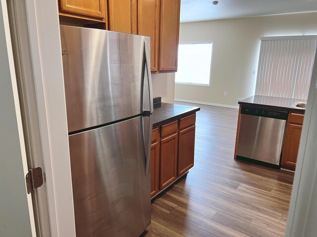 kitchen featuring appliances with stainless steel finishes and hardwood / wood-style floors