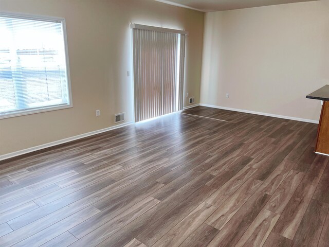 unfurnished room featuring dark wood-type flooring