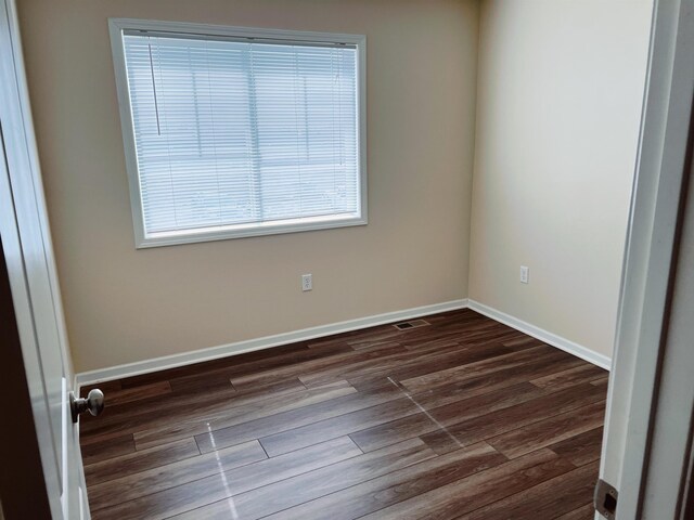 empty room featuring dark wood-type flooring