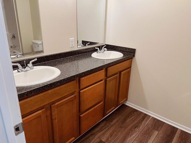 full bathroom featuring double vanity, tub / shower combination, toilet, and hardwood / wood-style flooring