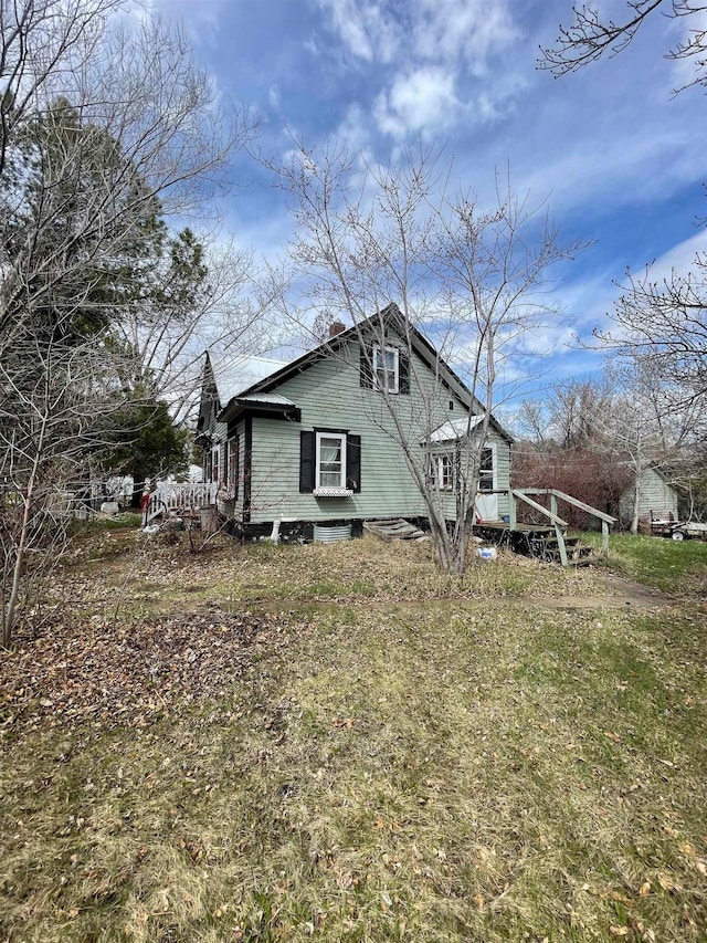 view of home's exterior with a lawn