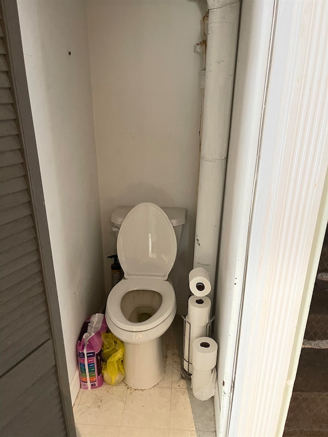 bathroom featuring toilet and tile floors