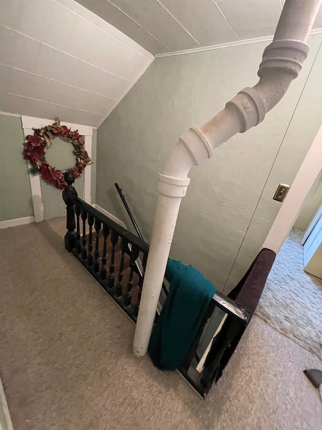 staircase featuring carpet floors and lofted ceiling