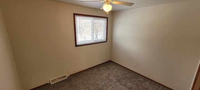 spare room featuring ceiling fan and dark carpet