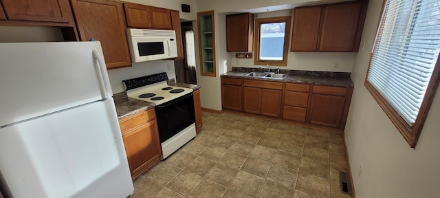 kitchen featuring white appliances and sink