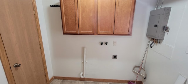 laundry room featuring cabinets, electric dryer hookup, electric panel, hookup for a washing machine, and light tile patterned floors