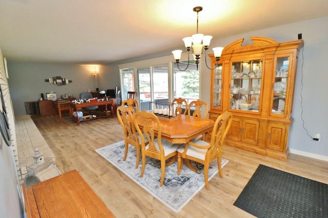 dining room featuring light hardwood / wood-style flooring and an inviting chandelier