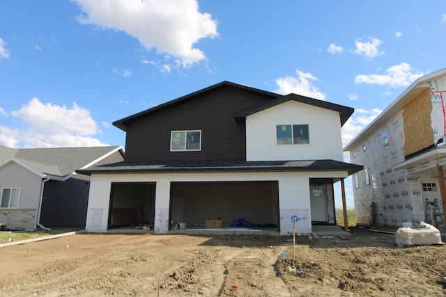 back of house with a garage