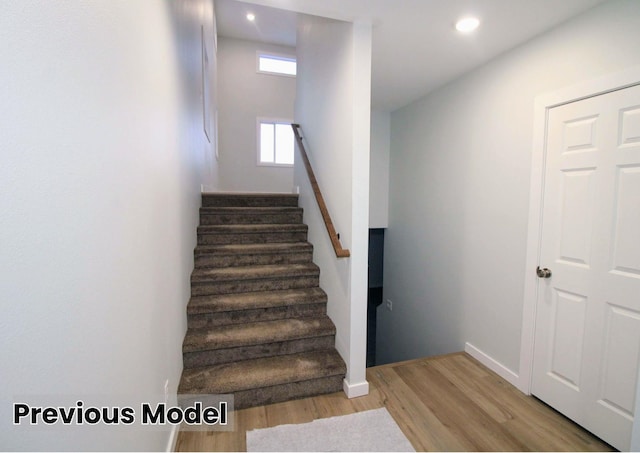 stairs with hardwood / wood-style floors