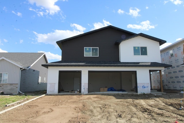 rear view of house with a garage