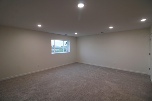 unfurnished room featuring dark carpet