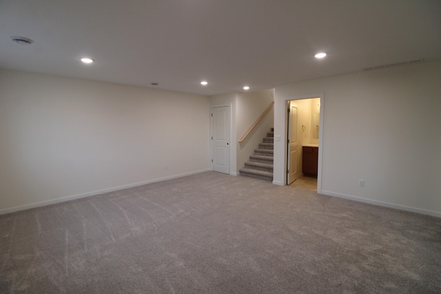 basement featuring light colored carpet